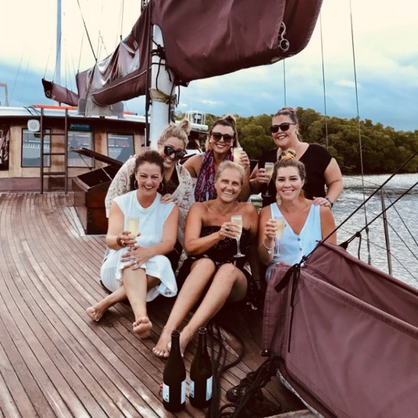 a group of people on a boat posing for the camera