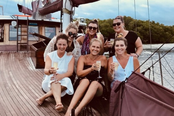 a group of people on a boat posing for the camera