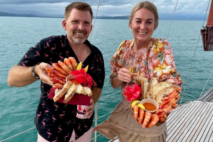 a man and a woman standing next to a body of water