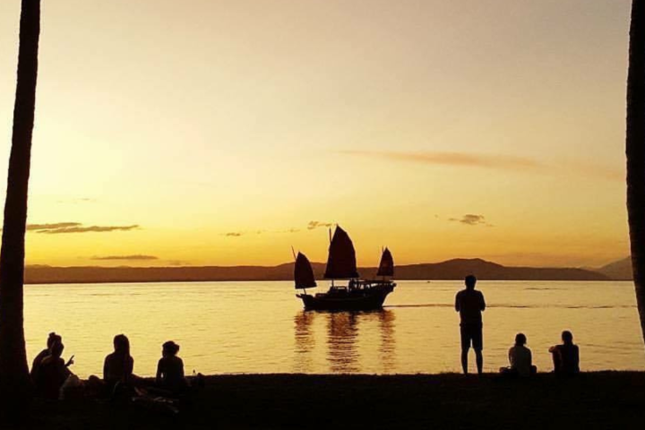 a group of people in a boat on a body of water