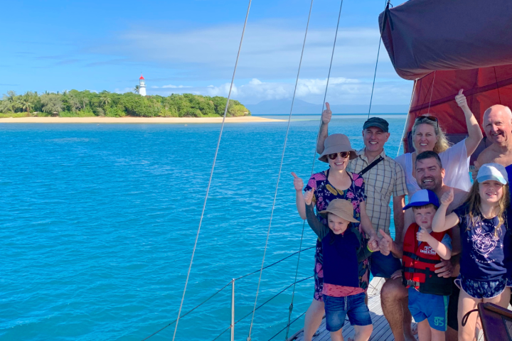 a group of people standing next to a body of water
