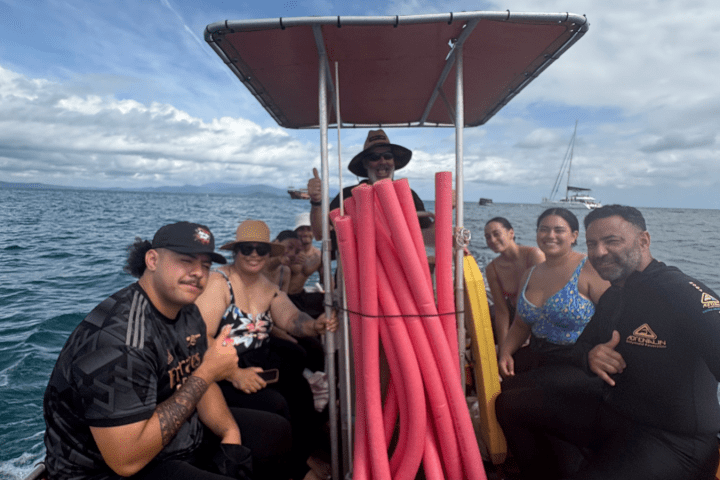 a group of people in a boat on a body of water